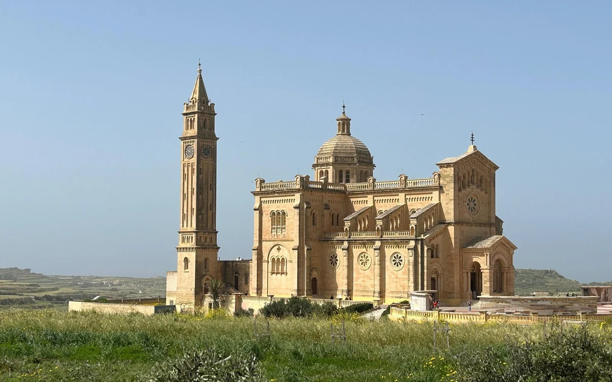 The Ta’ Pinu basilica among green fields on Gozo, its tall bell tower on the left