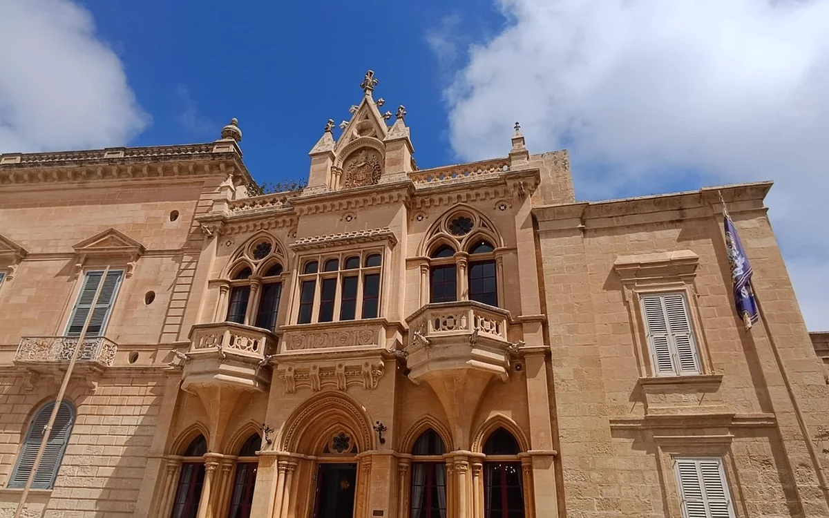 A palazzo in Mdina with carved stone balconies and pointed-arch windows