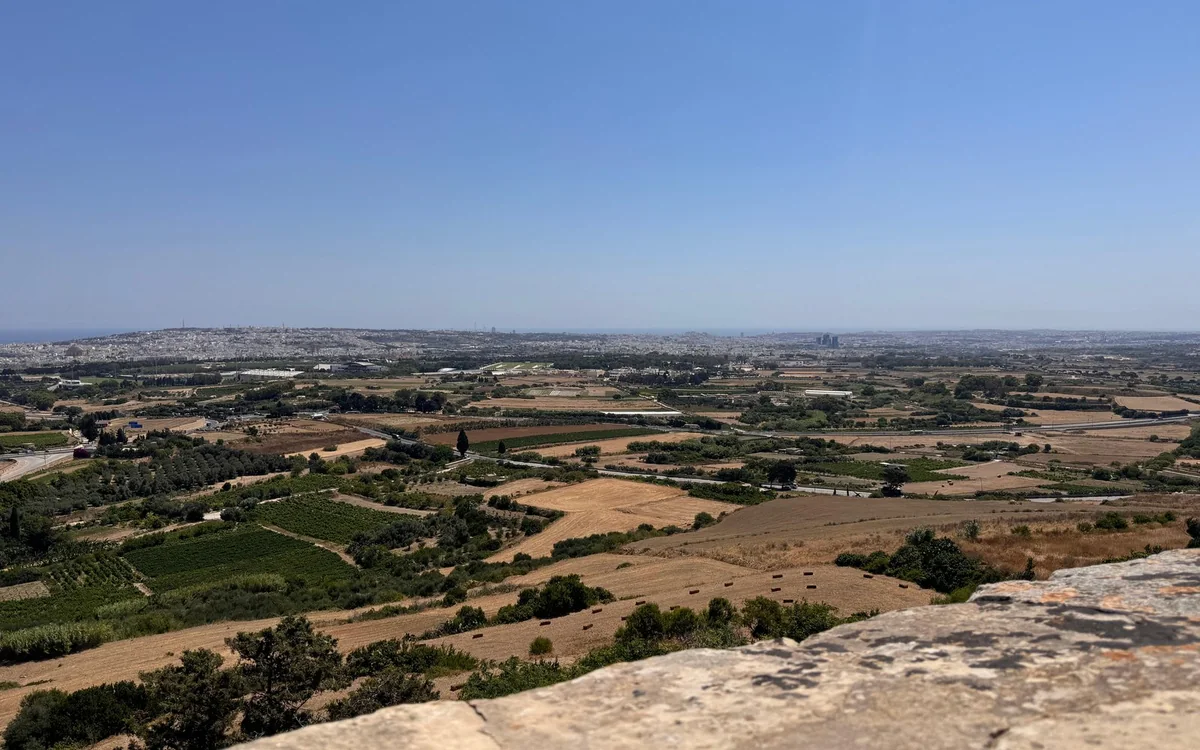 Fields, villages and the sea on the horizon below the Mdina bastions